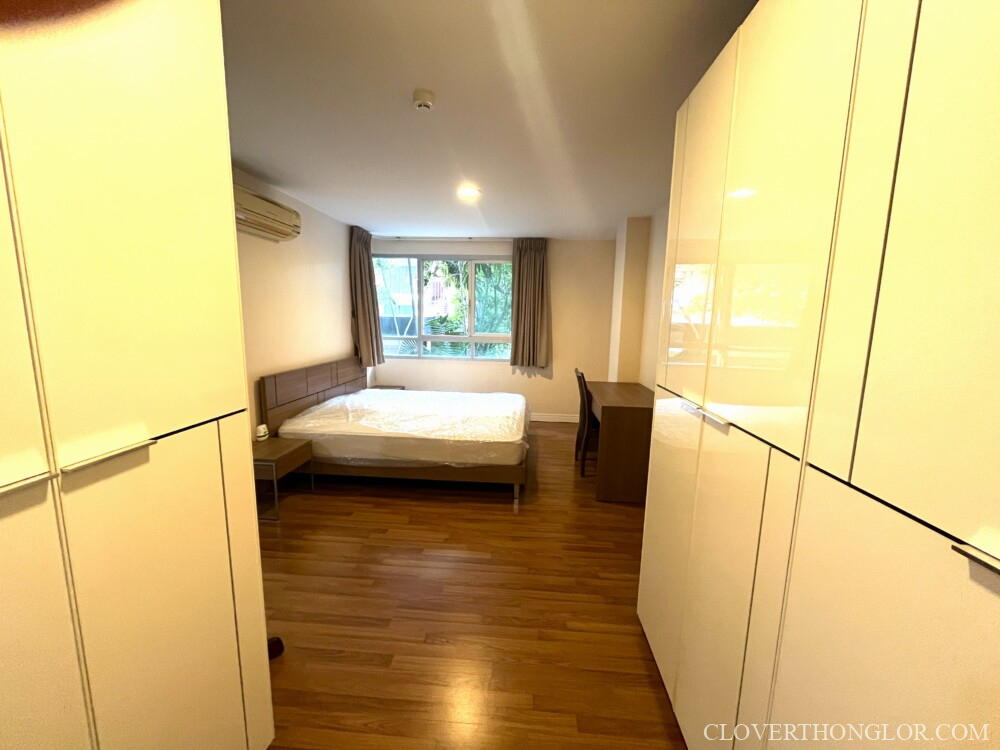 Spacious bedroom with wooden flooring