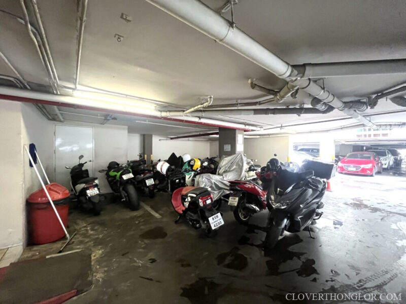 Designated indoor parking area for motorcycles at The Clover Thonglor. The basement level space is well-utilized for various resident two-wheelers.