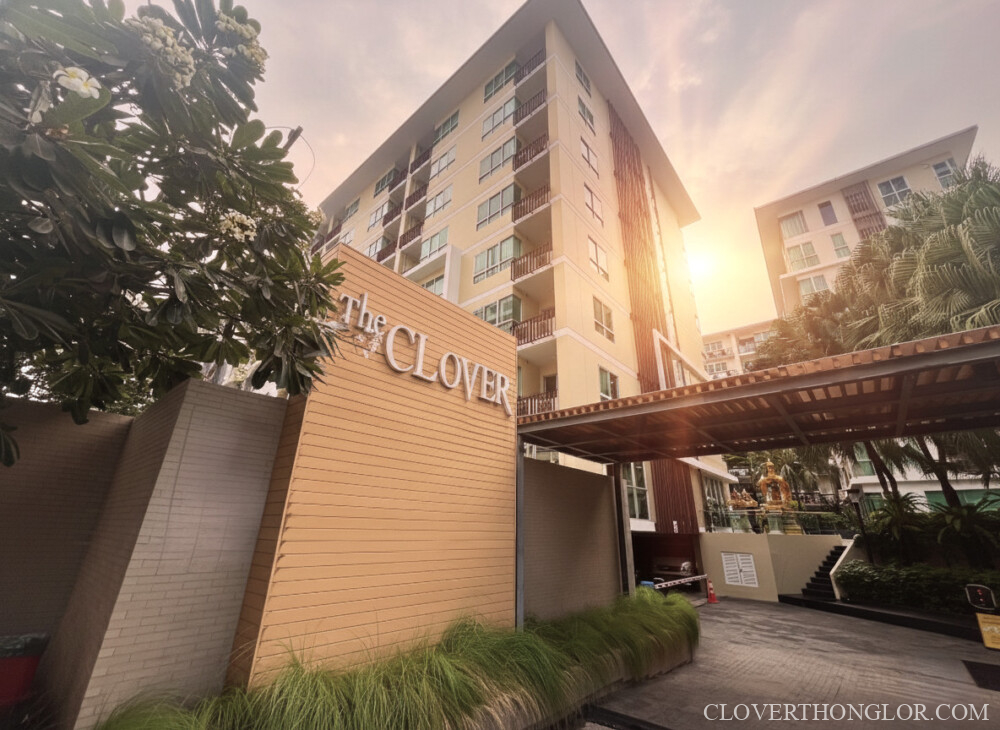 Front entrance sign of The Clover Thonglor Residence, a low-rise condo, bathed in the warm glow of the sunrise in the Thonglor district of Bangkok.