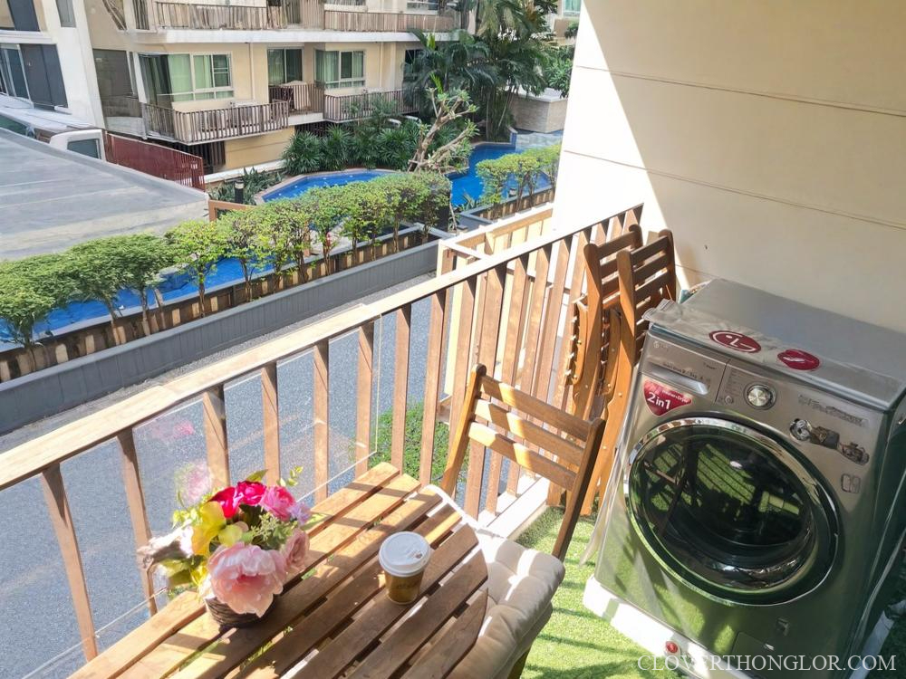 Balcony with washing machine and flowers