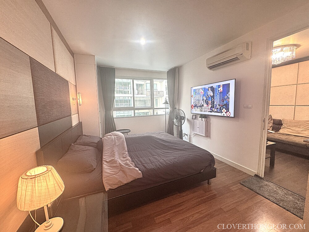 Modern bedroom with large TV