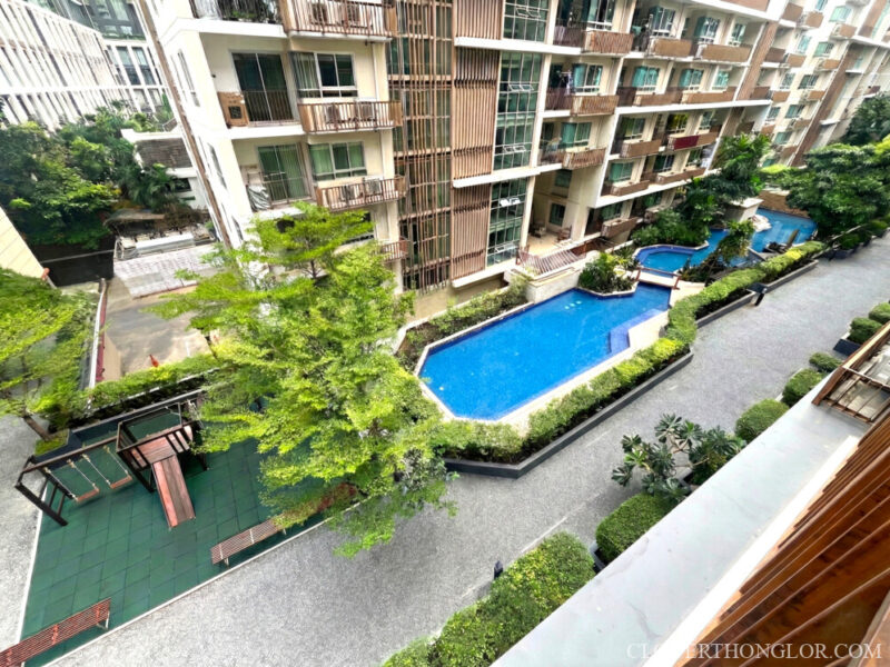 Kids pool and kids playground surrounded by garden at The Clover Thonglor